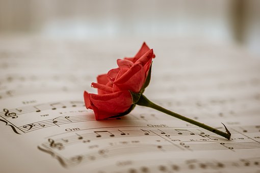 Pandora radio advertising with image of sheet music and a red rose