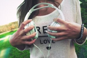 SiriusXM radio advertising image of girl holding headphones