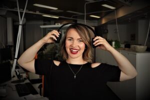 Smiling woman listening to podcast